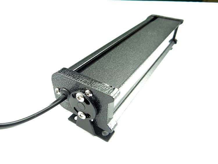 Black LED light bar with a power cable, on a white surface.
