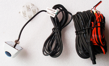 A white car camera with cable, black cord, and red/black power wires coiled.