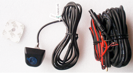 Backup camera kit with camera, cables, and mounting tape.