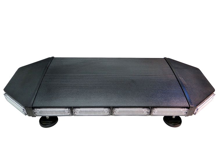 Black emergency vehicle light bar with white and blue lights.