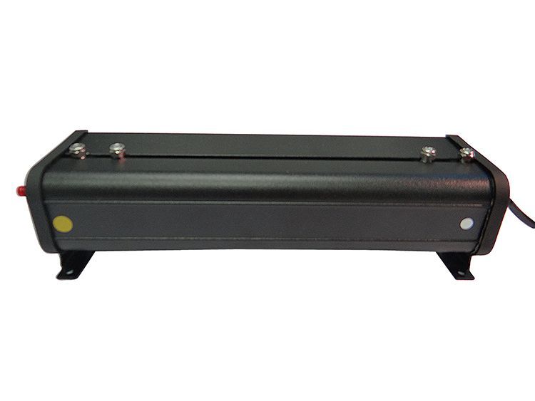 Black rectangular electronic device with four silver posts, small feet and a power cable.