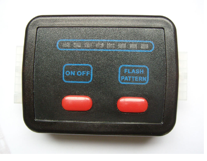 Black control box with blue text, red buttons, and a light bar.