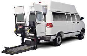 White wheelchair accessible van with lift extended.