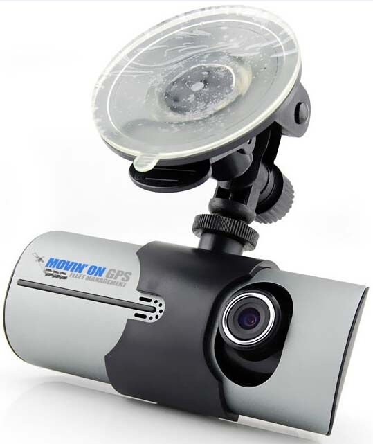 Dashcam with suction cup mount attached, gray and black with a lens, on a white background.