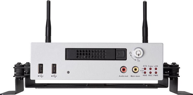 Silver electronic device with antennas, USB ports, and audio/video inputs, mounted in a black bracket.