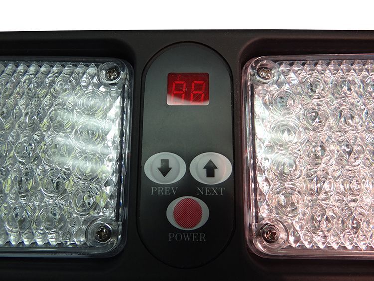 Control panel with a digital display and buttons, flanked by LED lights.