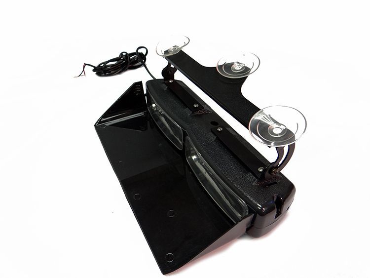 Black strobe light bar with suction cups, used for emergency vehicles.