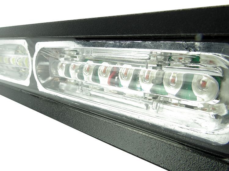 Black emergency light bar with clear lens housing, containing multiple white and red LEDs.