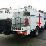 White utility truck with red arrow pointing towards a side compartment.