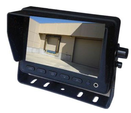 Rearview camera monitor displaying a loading dock. The monitor has a sun visor and is black.