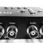 Close-up of a black video device with input and output ports labeled