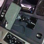 Dashboard with a grey box and mounted device, likely in a vehicle's interior.