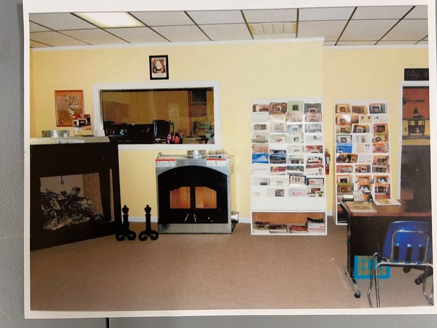 A picture of a living room with a fireplace