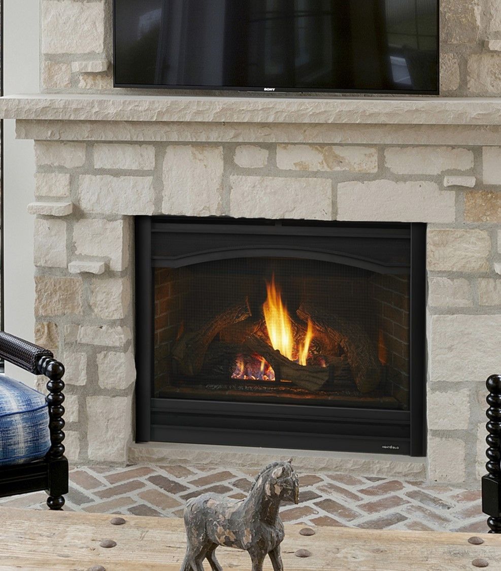 A fireplace with a statue of a goat in front of it