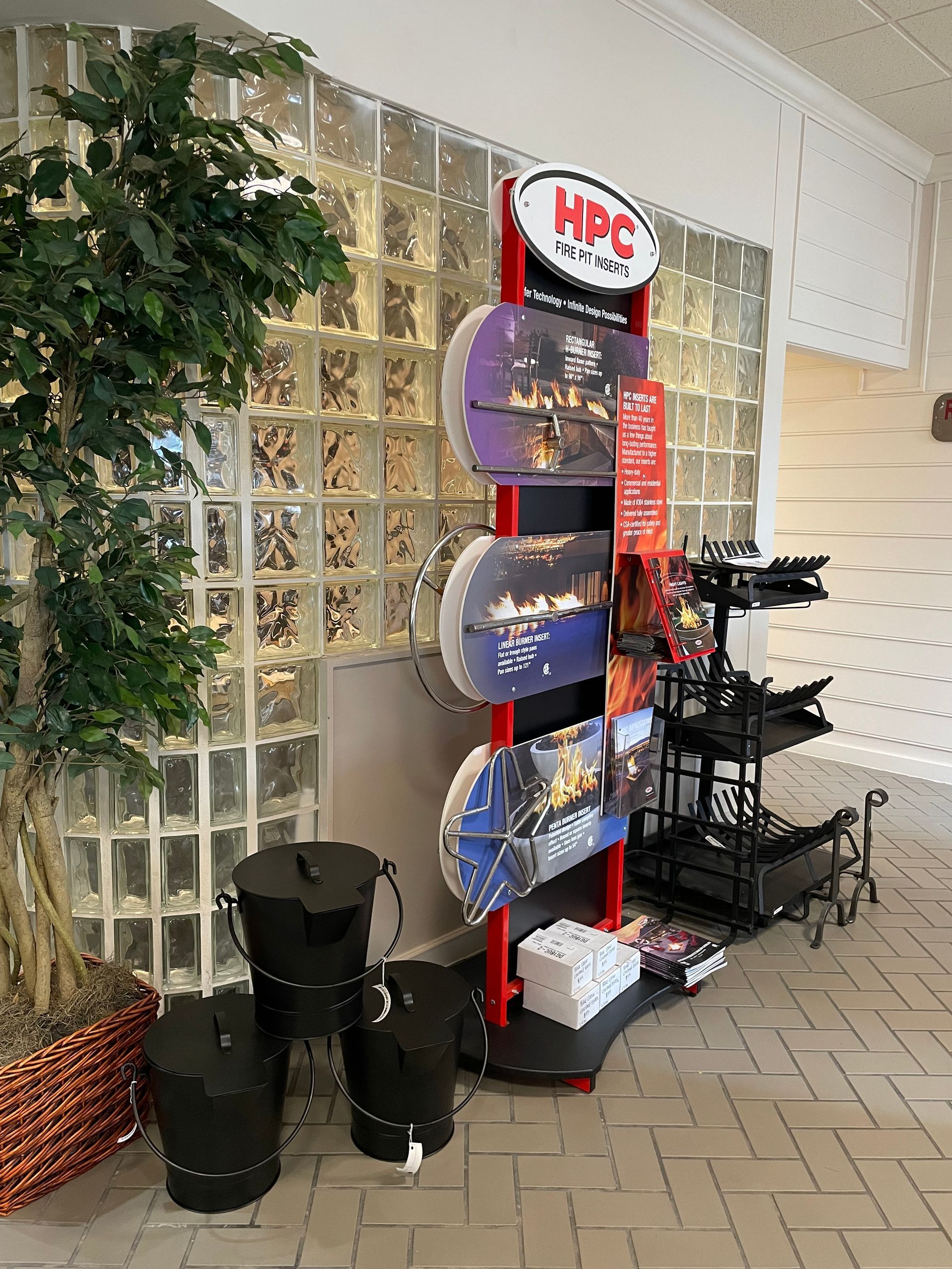 A display of hpc products is sitting in front of a glass wall.