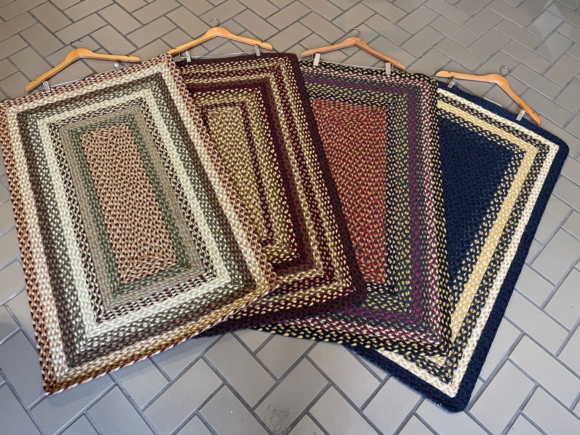 A bunch of rugs are stacked on top of each other