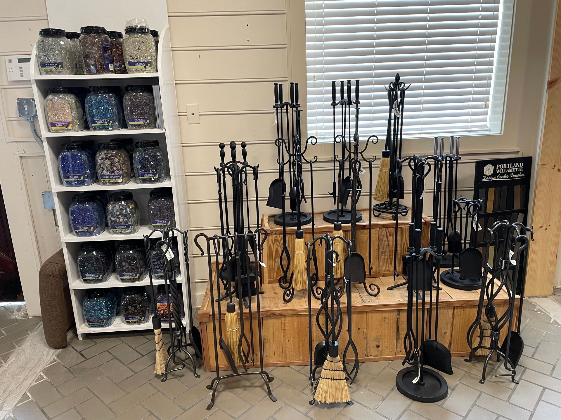 There are many different types of fireplace tools on display in this room.