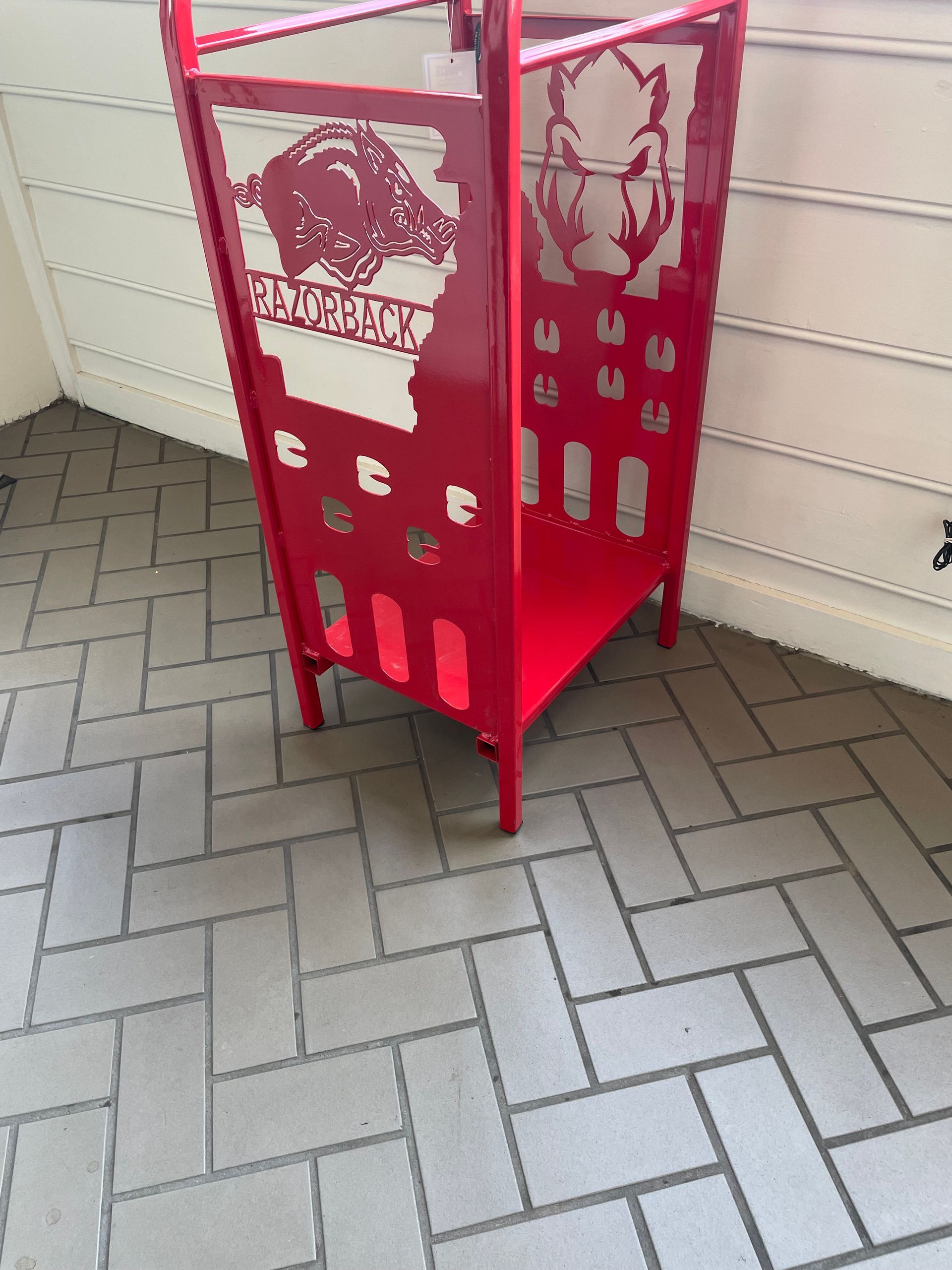 A red umbrella stand with alabama on it