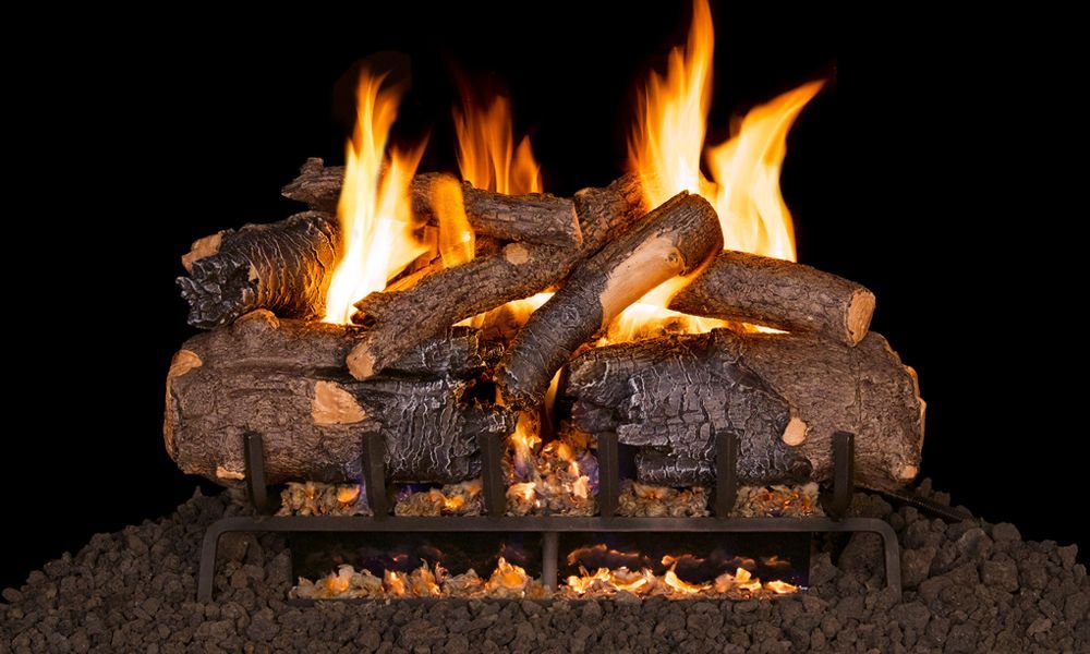 A fireplace filled with logs and flames on a black background.