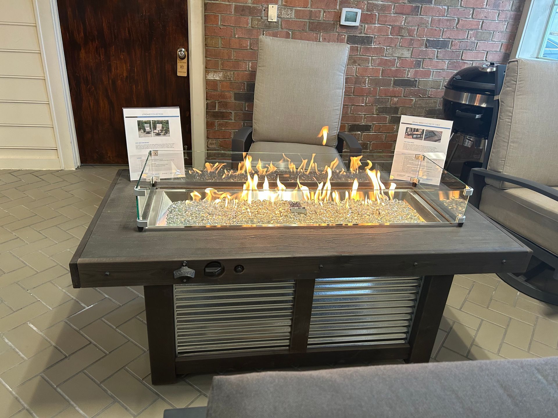 A fire pit is sitting on top of a wooden table in a living room.