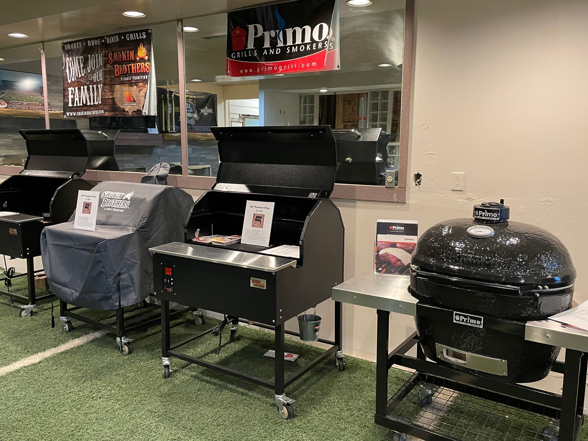 A bunch of grills are sitting on tables in a room.