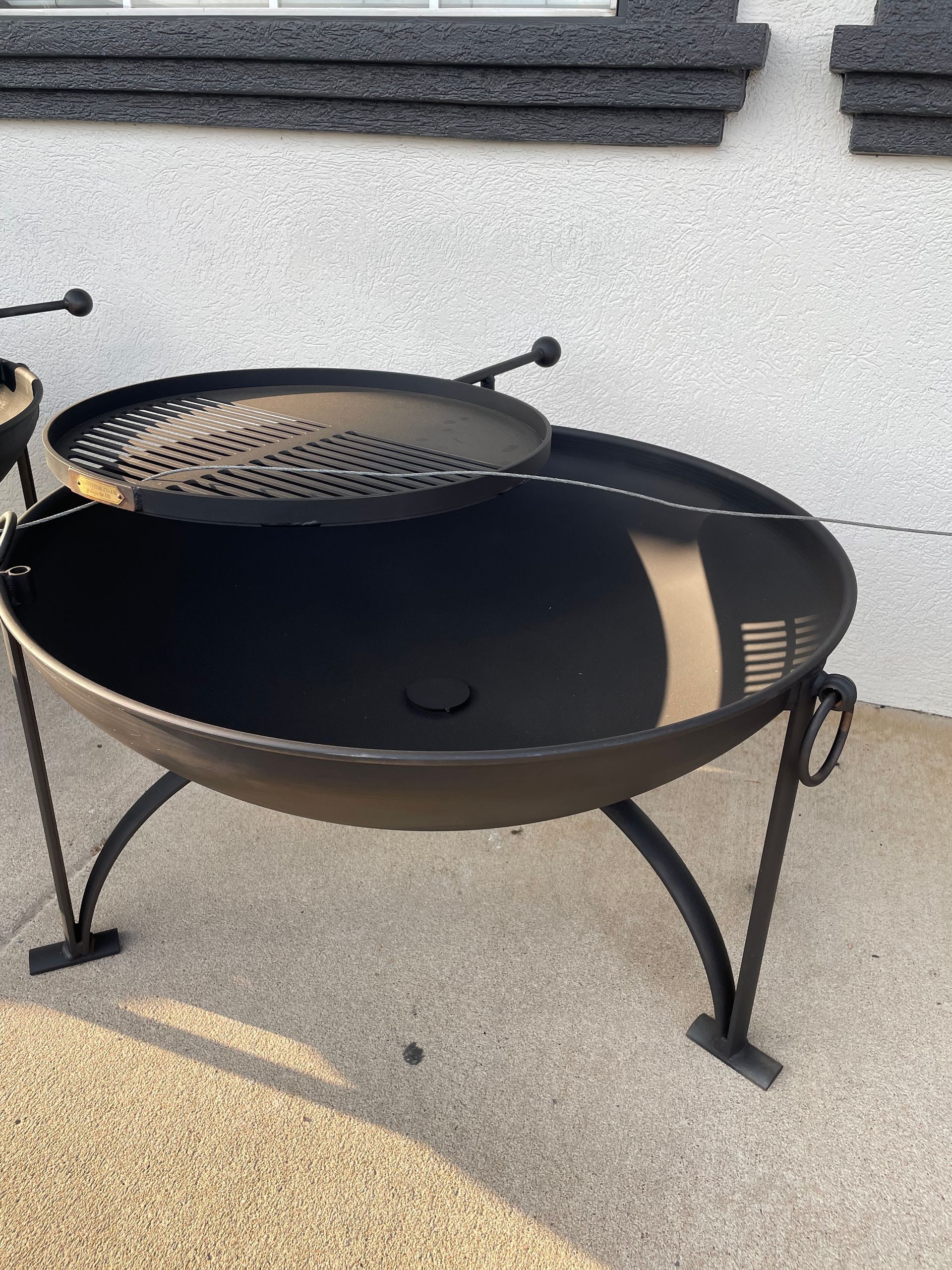 A fire pit with a grill on top of it