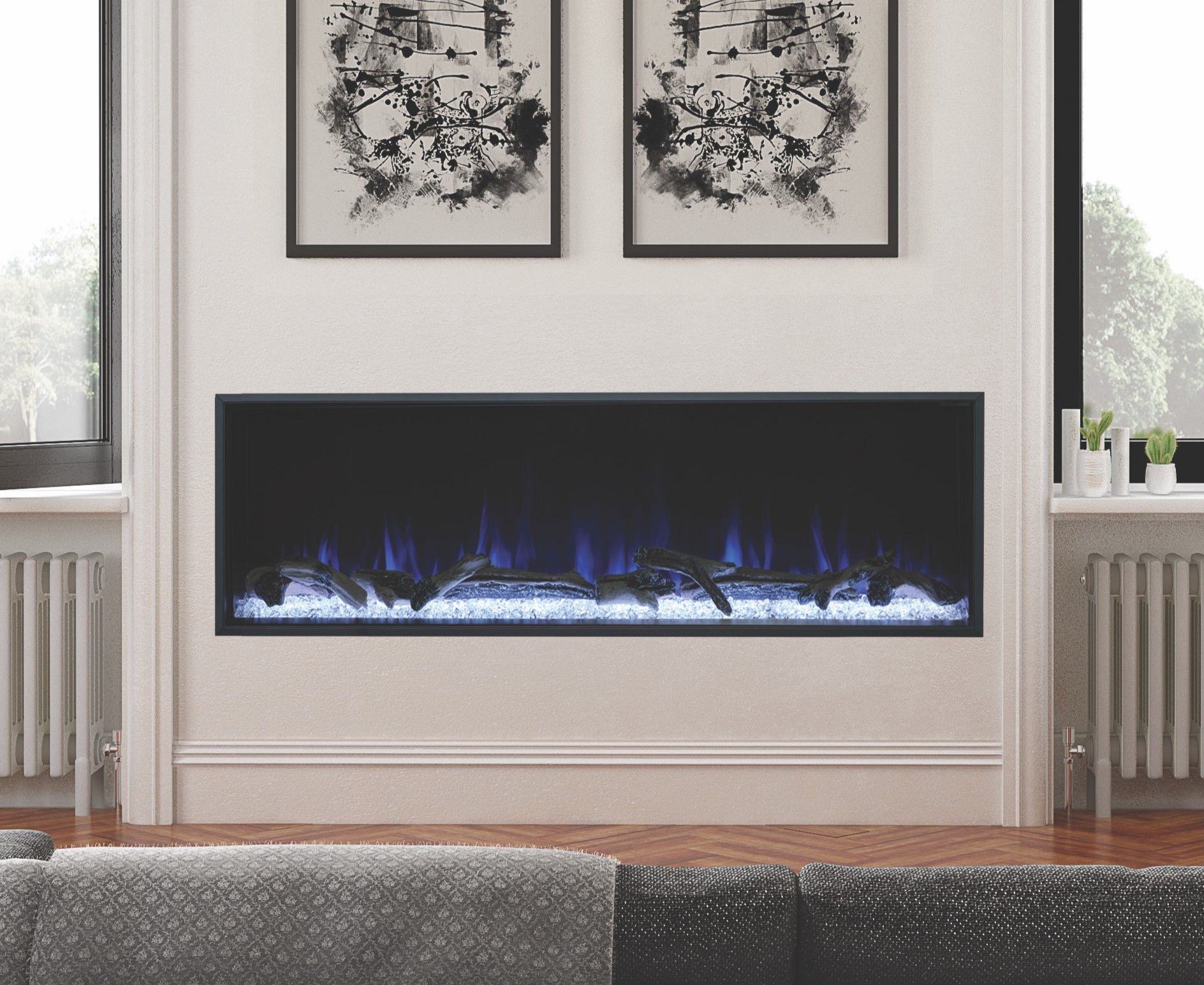 A living room with a fireplace and two paintings on the wall.