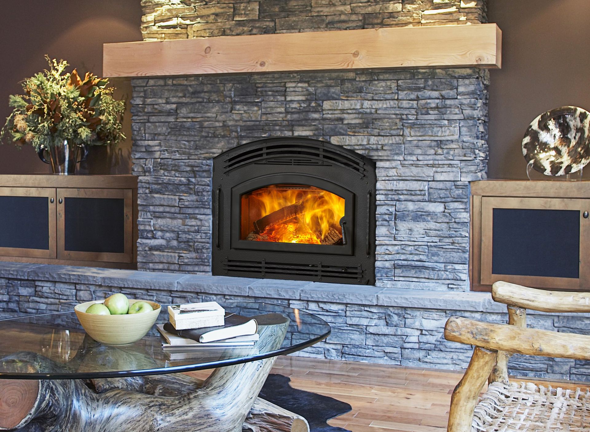 A living room with a fireplace and a glass table