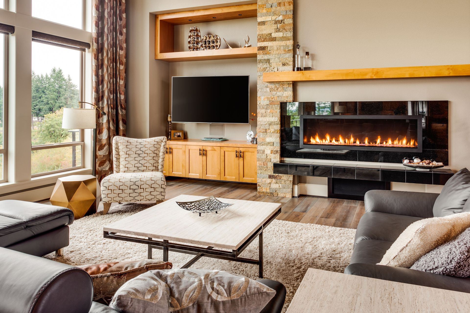 A living room with a fireplace , couch , chair and television.