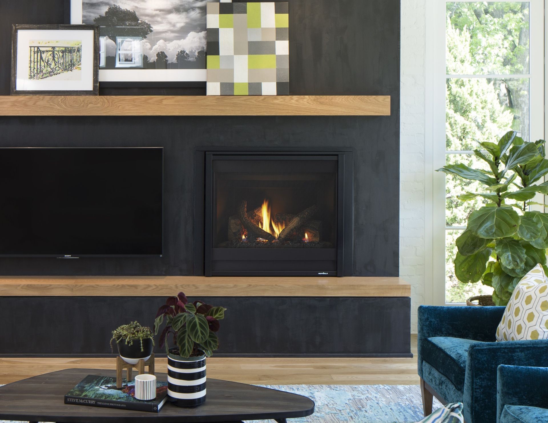 A living room with a fireplace and a flat screen tv.