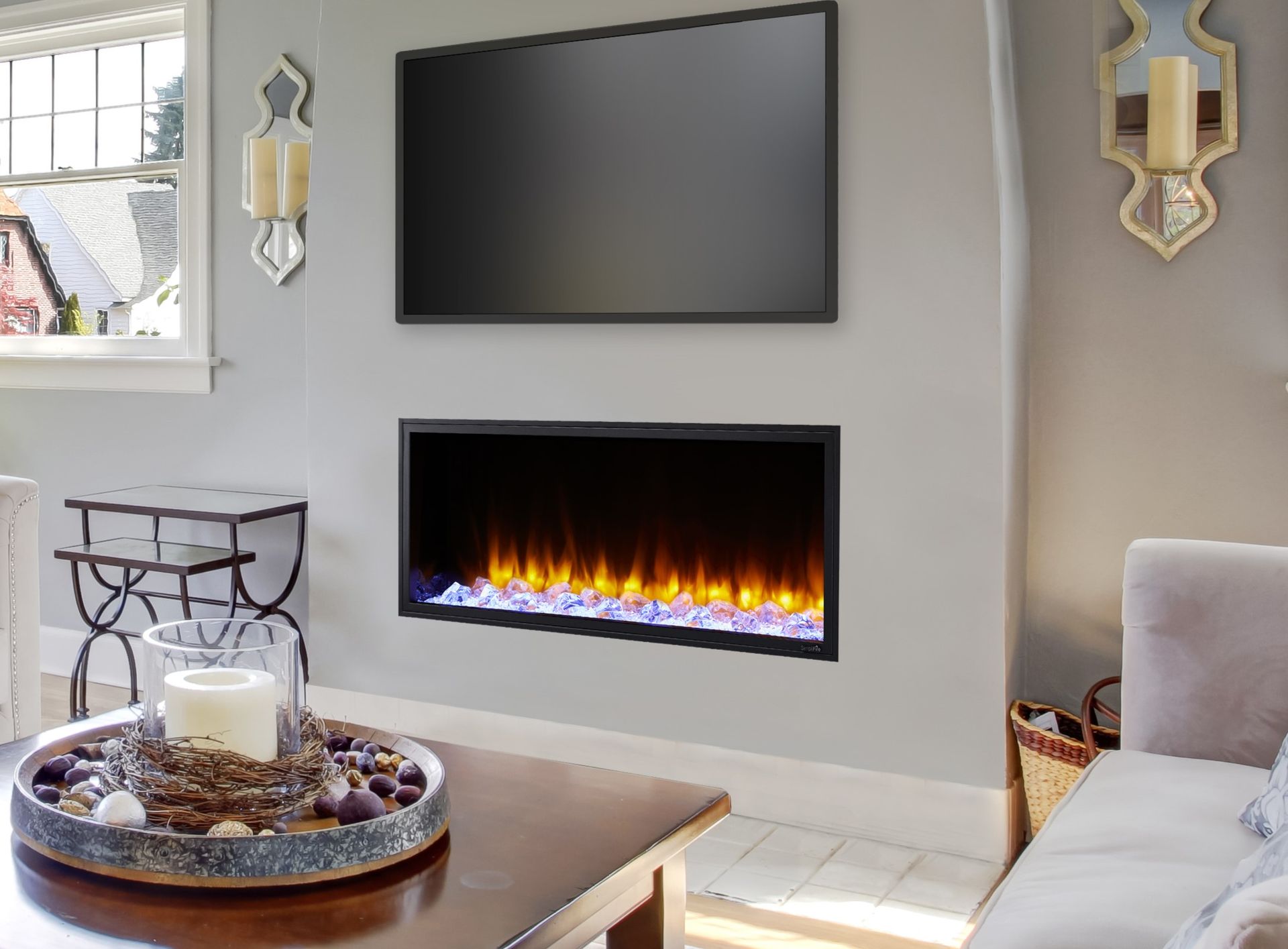 A living room with a fireplace and a flat screen tv.