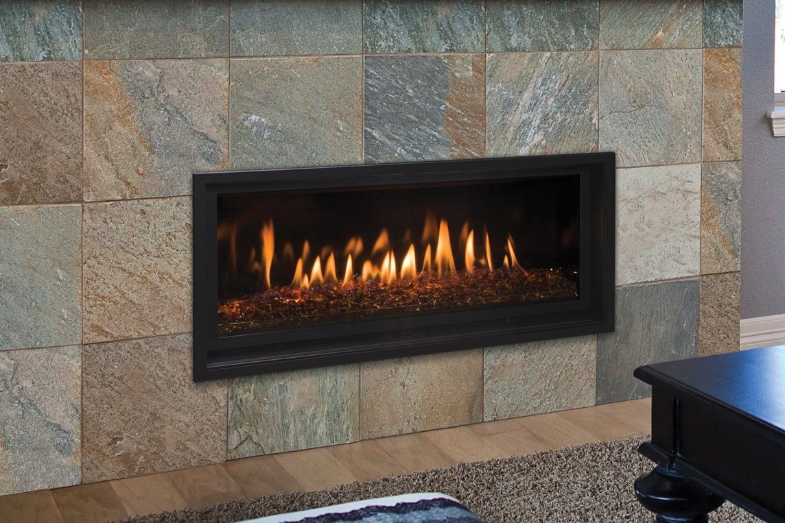 A living room with a fireplace and a coffee table.