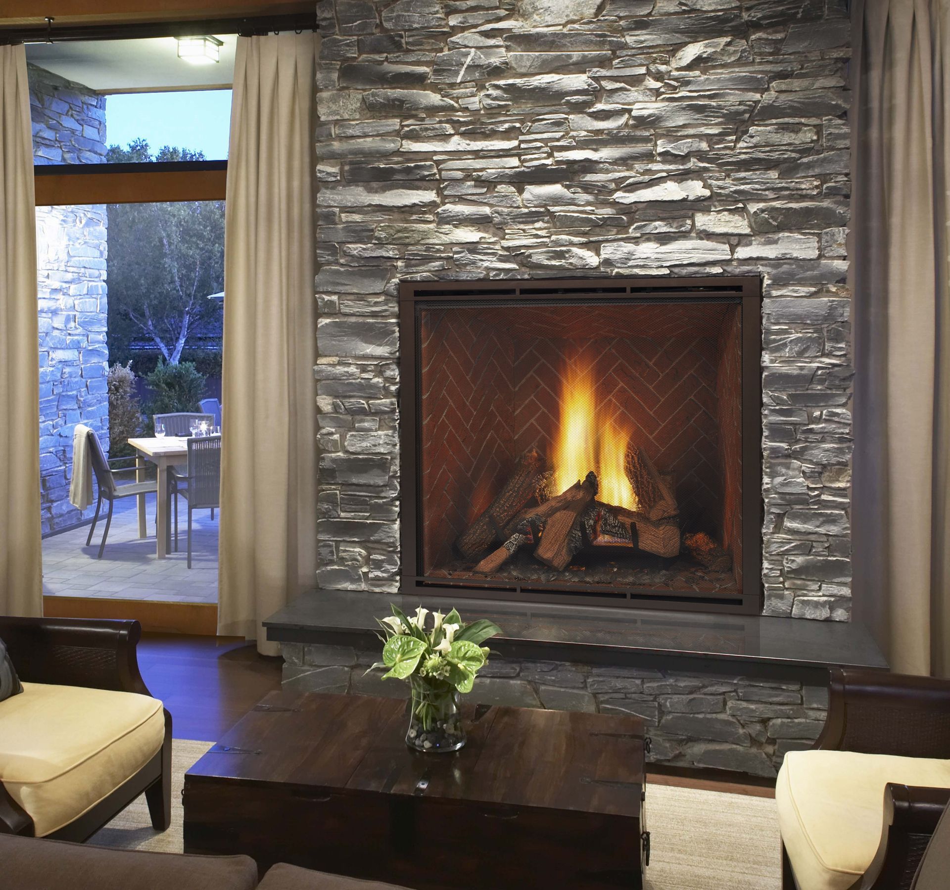 A living room with a fireplace and a table