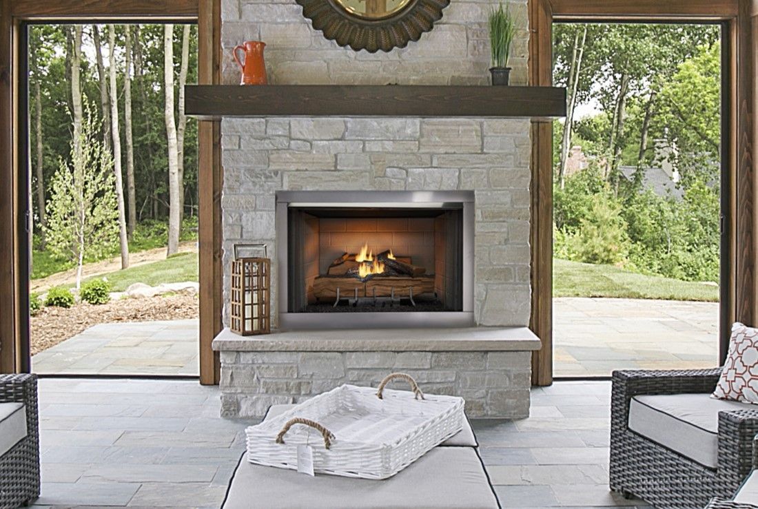 A living room with a fireplace and a clock on the wall.