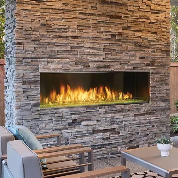 A fireplace is built into a stone wall.