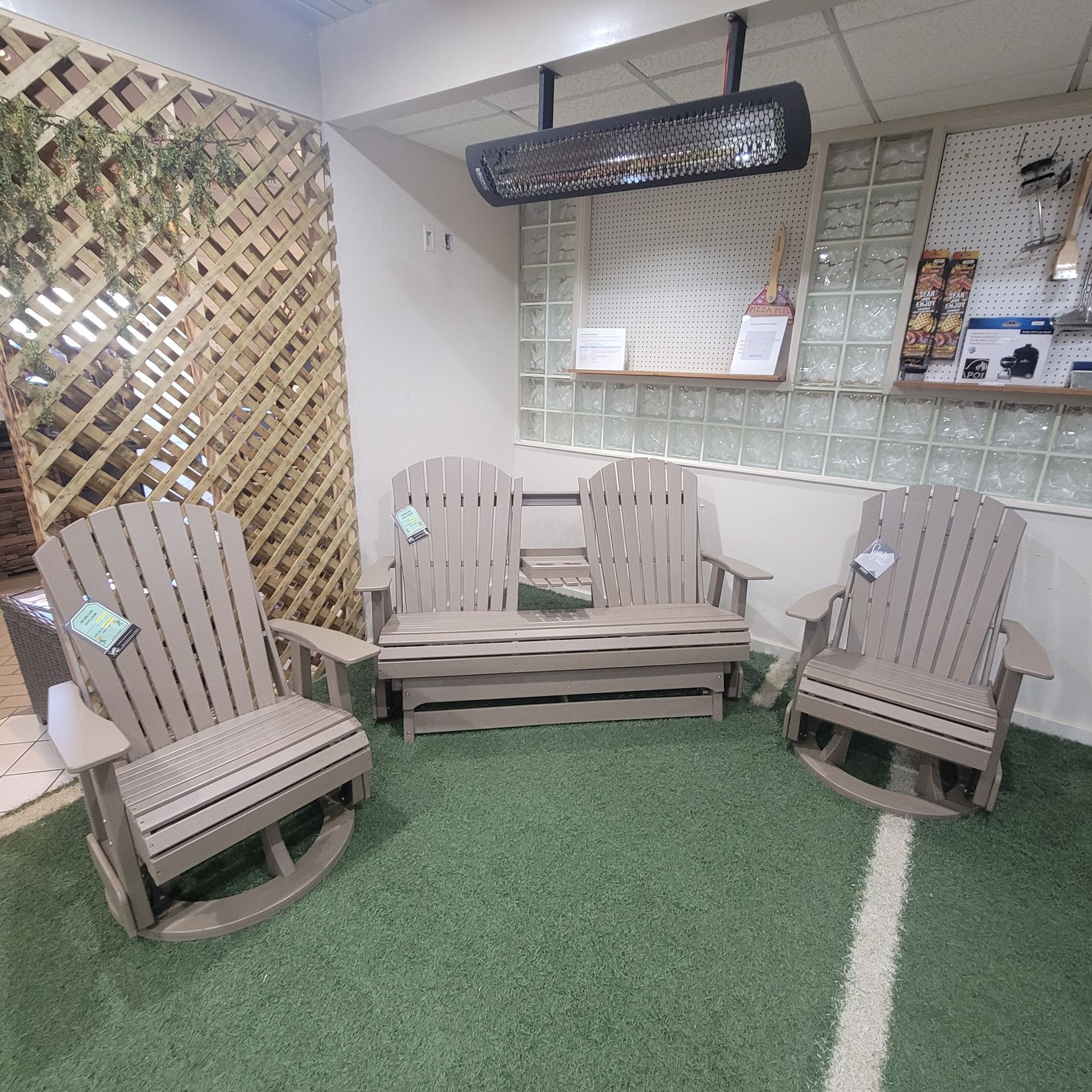 A living room with a couch, chairs, and a heater.