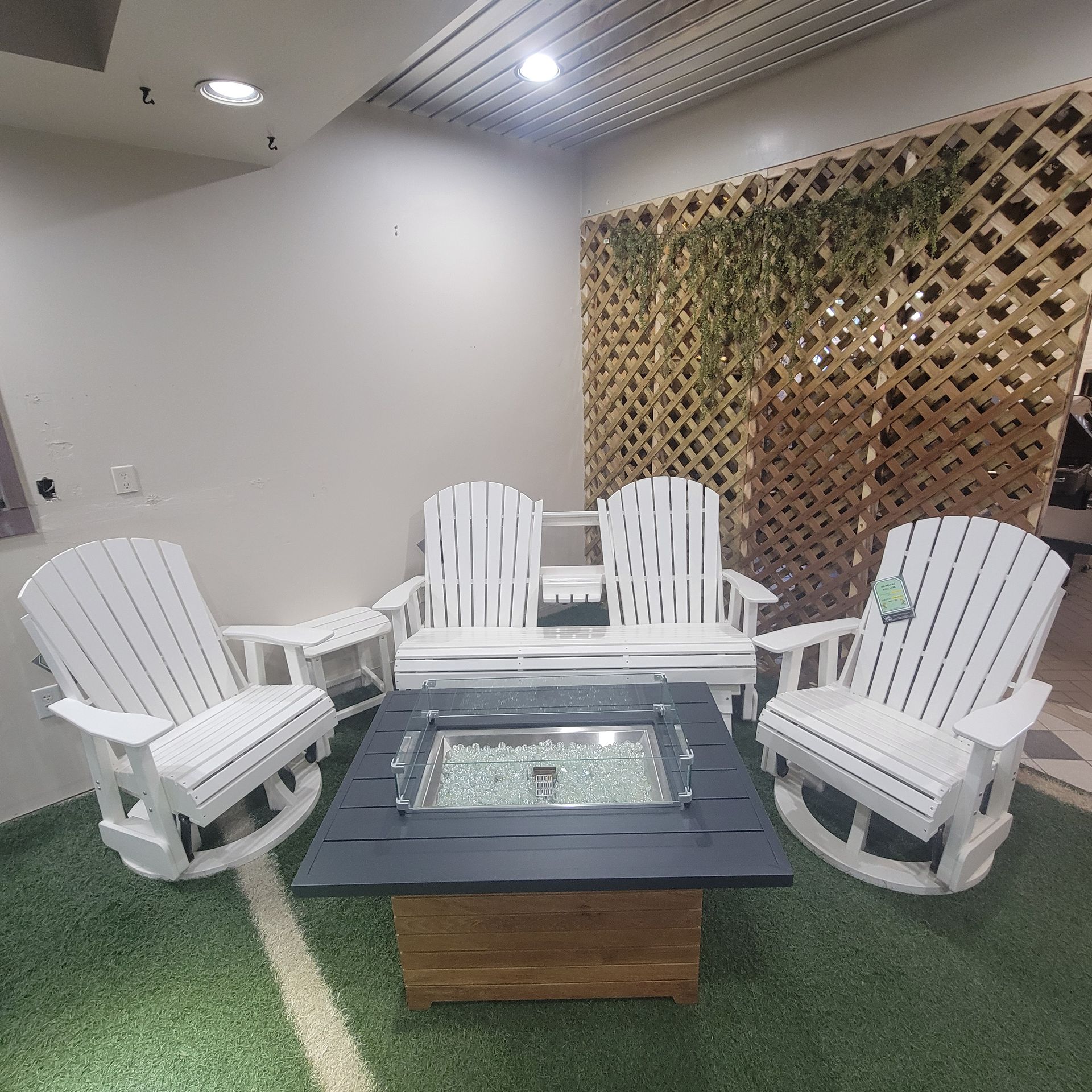 A living room with rocking chairs and a fire pit.