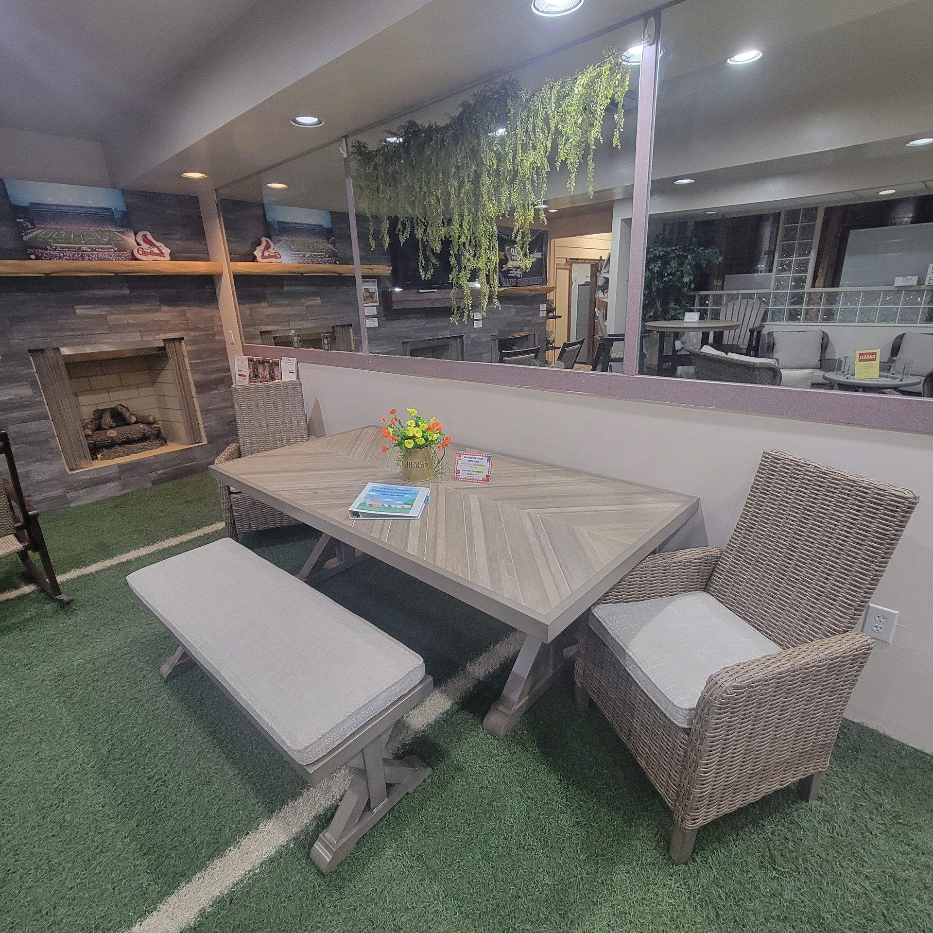 A dining room with a table, chairs, bench, and fireplace.
