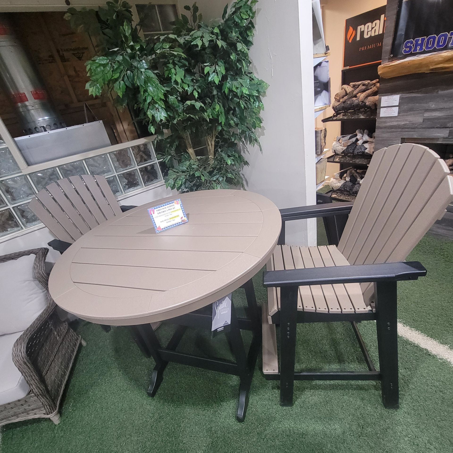 A table and chairs are sitting on top of a green grass-like carpet.