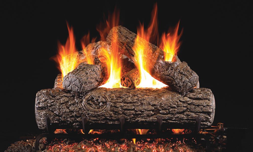 A fireplace with logs and flames coming out of it.