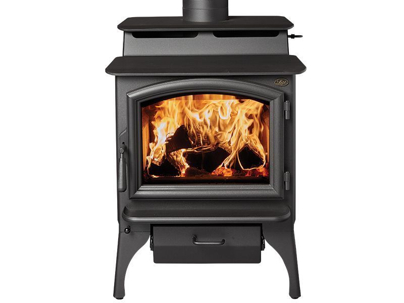 Black wood-burning stove with bright orange flames behind a glass door