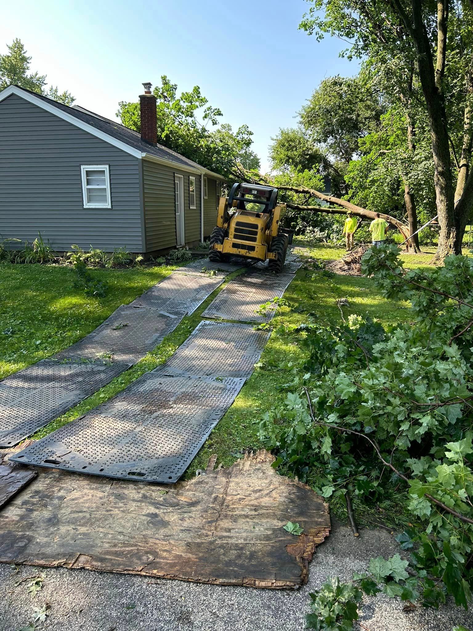 A house with a tractor parked in front of it