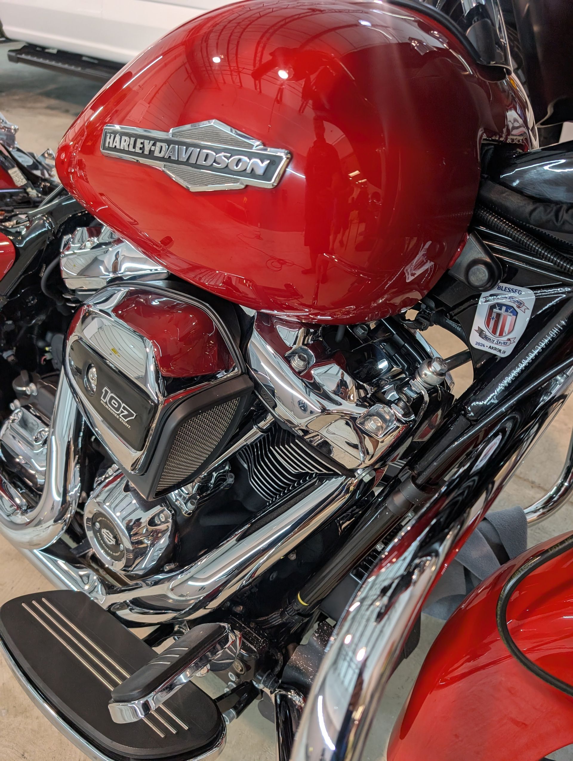 Close-up of a red Harley-Davidson motorcycle fuel tank and chrome engine parts