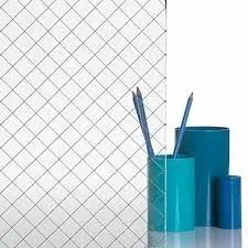 Glass with a diamond grid pattern, turquoise pen holders, and pencils on a white background.