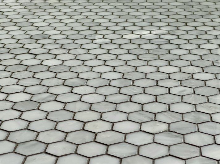 Hexagonal white-and-gray paving stones forming a tiled walkway pattern.