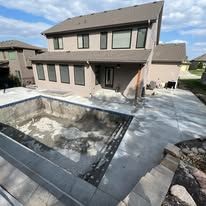 A large house with a swimming pool in front of it.