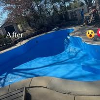A blue swimming pool with a blue tarp on top of it.