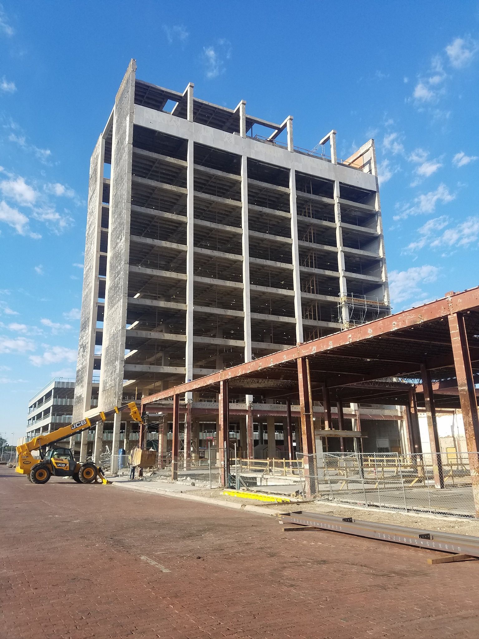 A large building under construction with a crane in front of it.