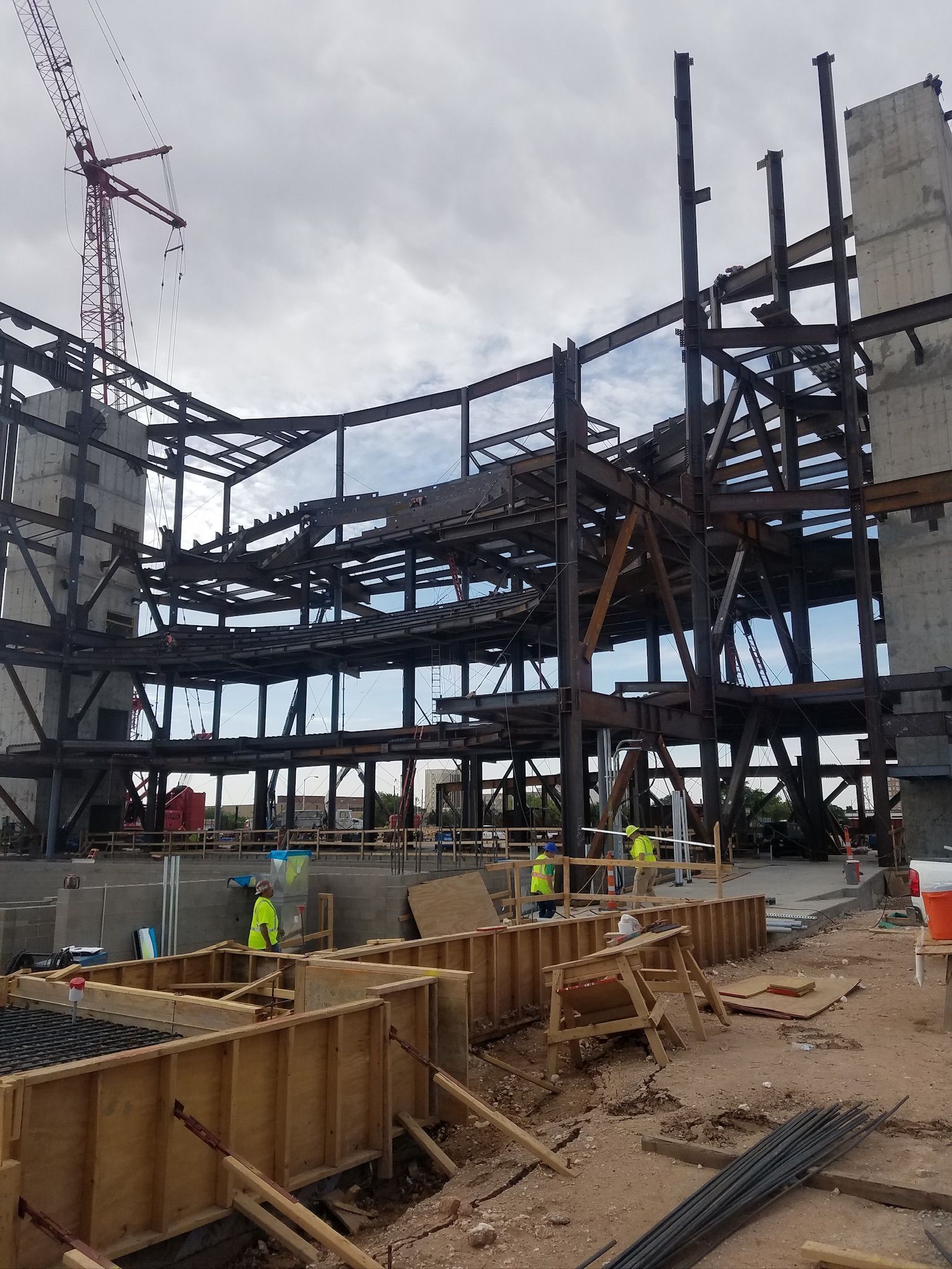 A large building under construction with a crane in the background.