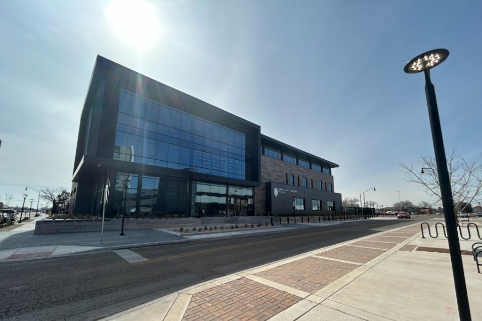A large building with a lot of windows and a street light in front of it.